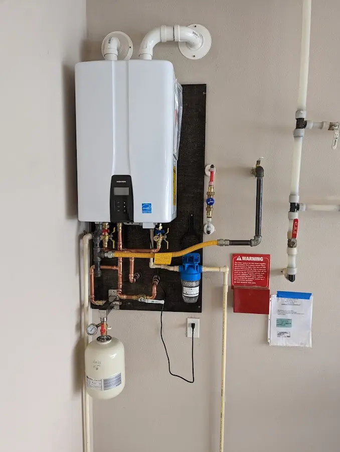 Professional plumber installing copper piping in a Claverack home